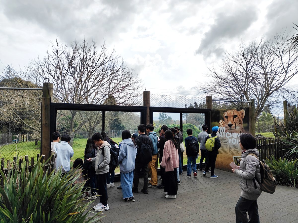 A group of WIE international students participating in an outdoor activity trip to Hamilton Zoo, standing...